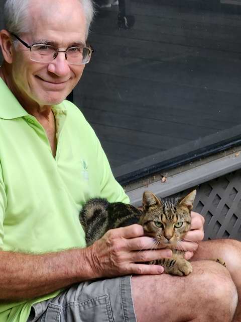 Gene with Tigger on the steps of the porch