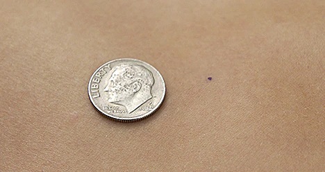 Size of tatoo compared with a dime