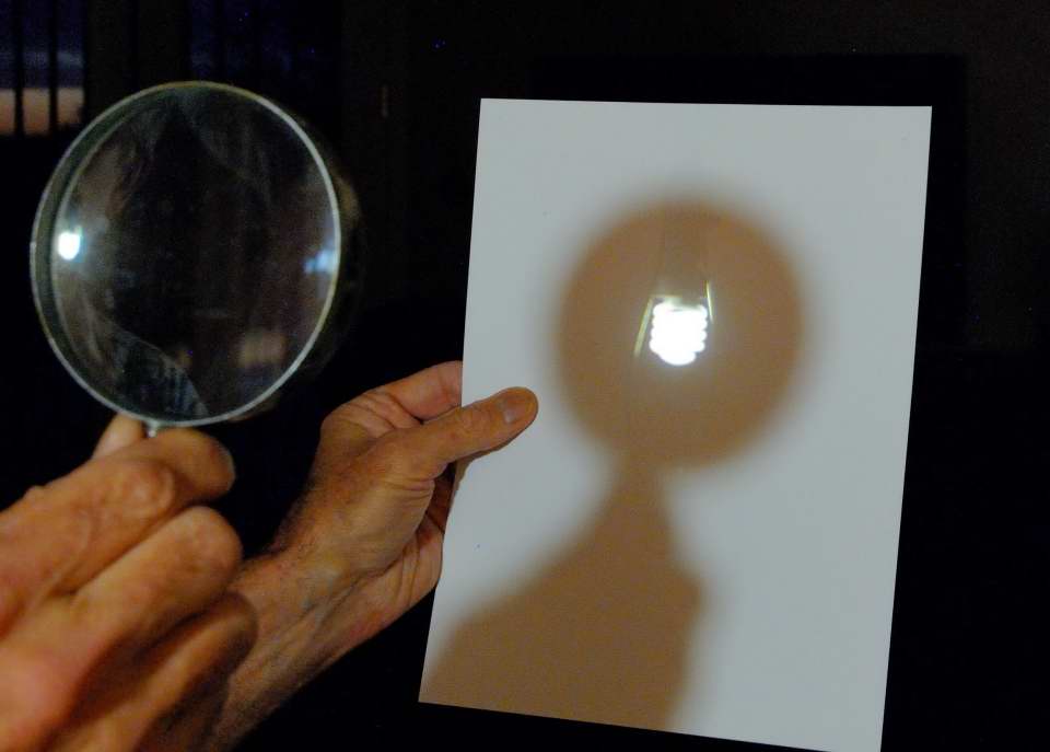 Light bulb projected onto paper with a magnifying glass. MAS image by Gene Hanson.
